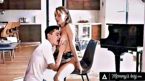 Stepson kneels sucking busty stepmom's exposed big tits in kitchen chair taboo scene