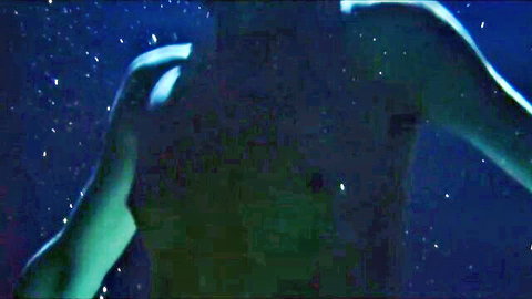 Mysterious underwater silhouette of glowing nude arm reaching in dark blue pool