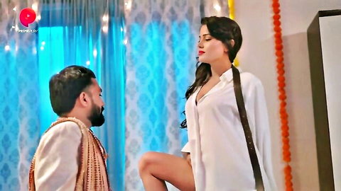 Seductive Indian housewife in open white shirt teases kneeling man exposing her thighs in festive room