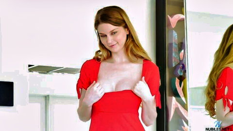 Bunny Colby teases big fake tits in sexy red dress mirror pose