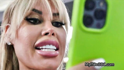 Blonde big-breasted casting director smiling in sexy selfie