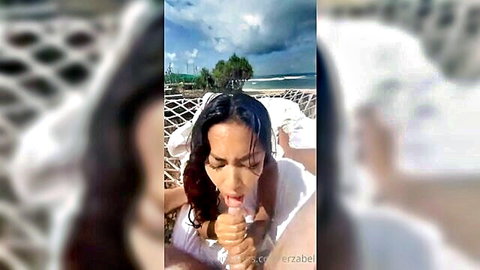 Asian beauty in white dress giving hammock blowjob outdoors