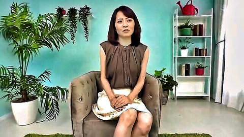 Elegant Asian woman in brown blouse and white skirt sitting poised