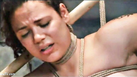 Bound Asian woman in ropes, BDSM distress expression