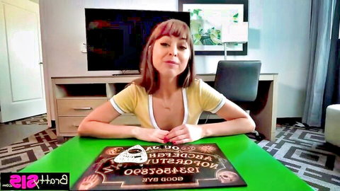 Brunette in low-cut yellow top sitting at Ouija board, step-sister tease