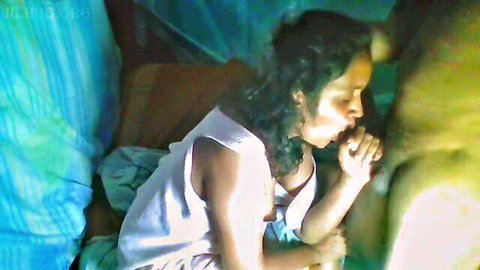 Ebony MILF giving intense blowjob to man in bed on vacation