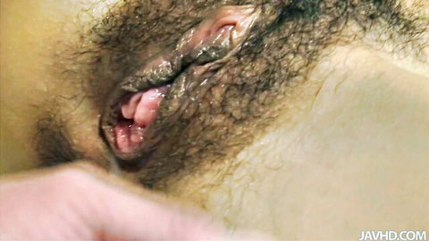 Close-up of wet hairy pussy spread wide open showing pink inner labia
