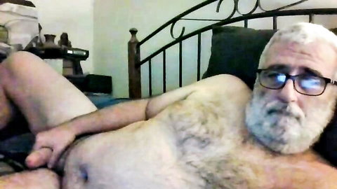 Hairy mature white man with beard and glasses masturbating solo