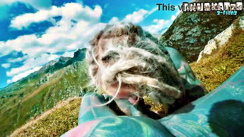 Wild-haired woman overlooking mountains in outdoor POV tease