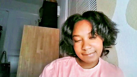 Young ebony beauty smiling seductively on webcam in tight pink top solo tease