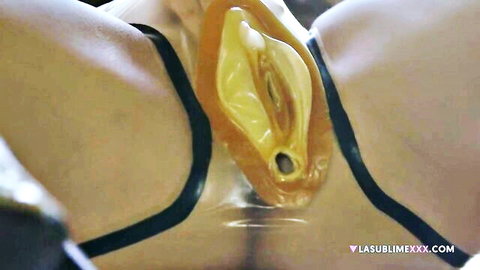 Closeup of olive-skinned beauty's wet shaved pussy penetrated by thick yellow transparent dildo toy