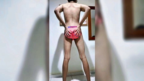 Slim twink pulls down pink briefs exposing tight bare ass from behind in amateur striptease