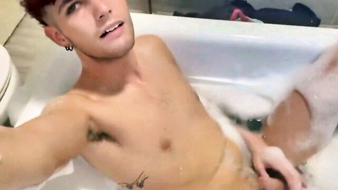 Naked gay twink in bubble bath selfie grabbing cock under foam