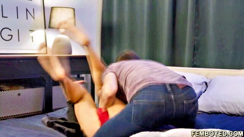 Guy with hard cock thrusting into femboy's exposed ass doggy style on bed with soles up