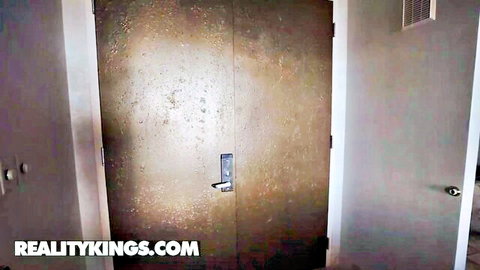 Rusty industrial double doors in dimly lit hallway before Reality Kings action