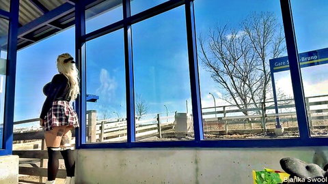 Blonde schoolgirl in short plaid skirt and thigh-highs at sunny bus stop, risky public tease