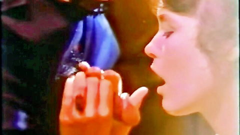 Vintage 1980s woman giving blowjob to man in classic porn scene