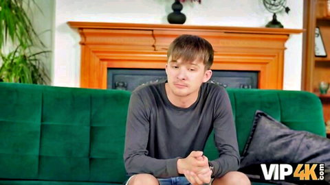 Young man sits thoughtfully on couch in Julia North & Suzie Sparklez family party sex scene