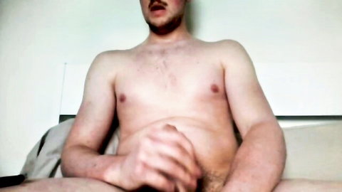 Young muscular gay guy masturbating solo on bed