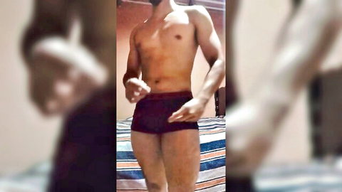 Hot young muscular Latino man posing in tight shorts