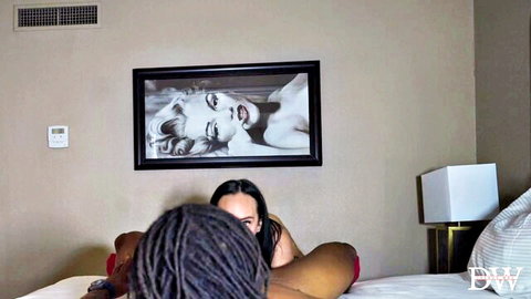 Smiling Latina spreads legs as black stud with dreads eats her pussy in hotel bed