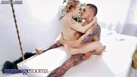 Tattooed blonde with perky tits passionately kisses nude muscular tattooed guy straddling his lap
