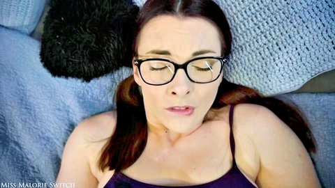 Miss Malorie Switch seductively reclining in purple lingerie with glasses