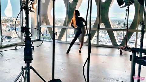 Nicole Doshi elegant solo pose in tight black outfit, city view