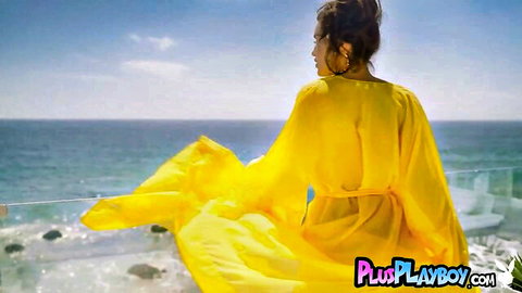 Hispanic MILF with big tits posing in flowing yellow dress by the sea for Playboy