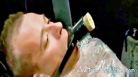 Mistress Tatjana tortures male slave with plastic wrap and bottle gag in femdom scene