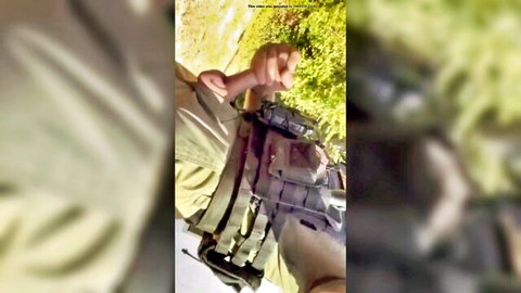 Hung straight officer in camo uniform outdoors, arm extended