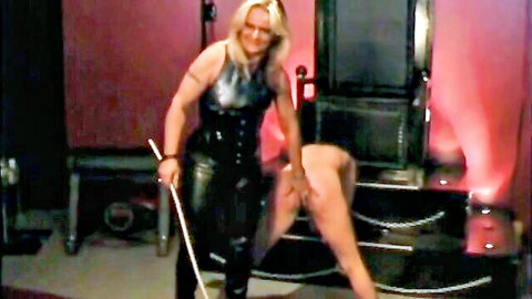 Blonde German mistress in latex outfit harshly caning nude submissive