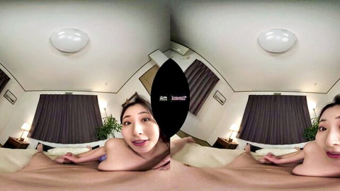 Smiling Japanese woman topless on bed in VR POV