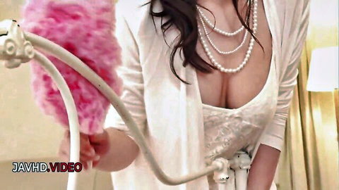 Japanese babe in white lace lingerie teases with pink feather duster exposing deep cleavage