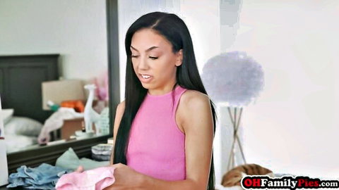 Petite Hispanic teen in pink tank top holding lingerie, stepfamily vibe