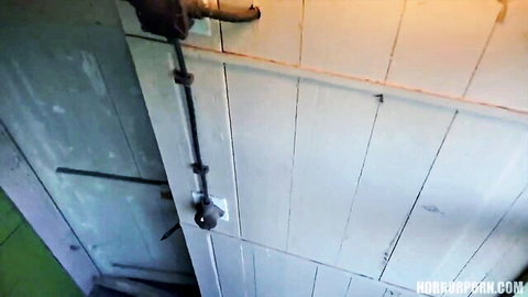 Close-up of ajar white wooden door with lock in dim-lit room teasing entry