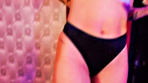 Tattooed stripper in black panties showing toned abs and curves