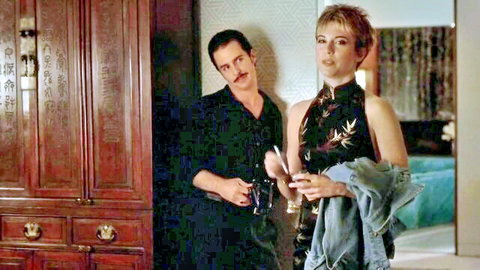 Rebecca Pidgeon in sexy black dress with man in Heist 2001 scene