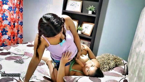 Pigtailed Asian lesbian squeezes her friend's tits on bed in steamy foreplay