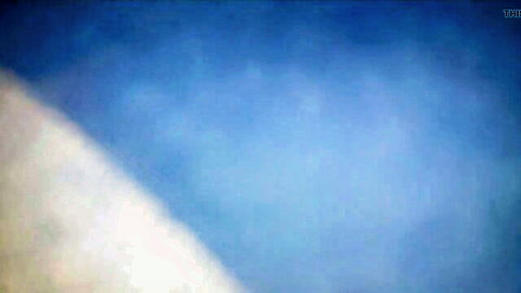 Blurry abstract blue background with white streaks in adult video frame