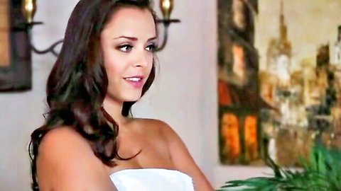 Seductive brunette in strapless white dress smiling during massage scene