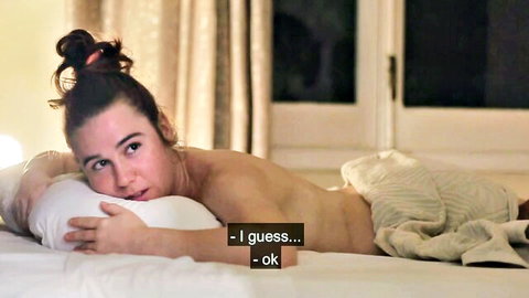Brunette woman topless on bed in softcore oily massage scene with Lucia