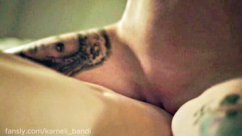 Close-up of tattooed woman's bare neck and shoulder in amateur nude tease