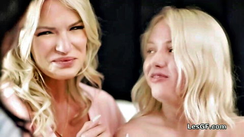 Blonde MILF in lingerie intimately touches young nude blonde's face