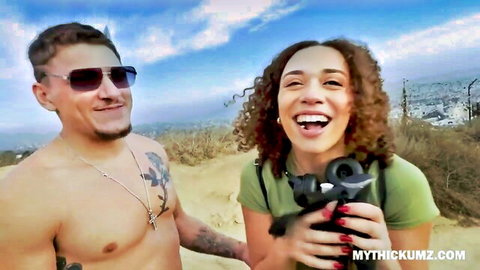 Smiling mixed-race couple on hiking trail pickup, wild adventure ahead