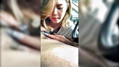 Blonde Asian woman intimately caresses hairy male chest in car during steamy foreplay tease