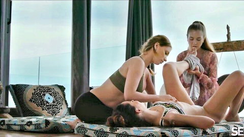 Three fit women in sensual lesbian massage on outdoor retreat