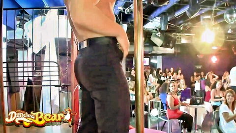 Shirtless muscular hunk grinds stripper pole with tight ass pants at CFNM Dancing Bear party for cheering women