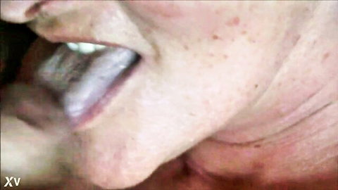 Closeup of mature granny with open mouth and tongue out, cum in throat