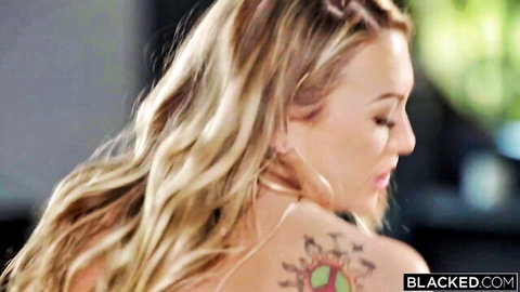 Adira Allure blonde with colorful shoulder tattoo in seductive profile